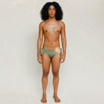 Front view of model wearing green knotted bikini bottom