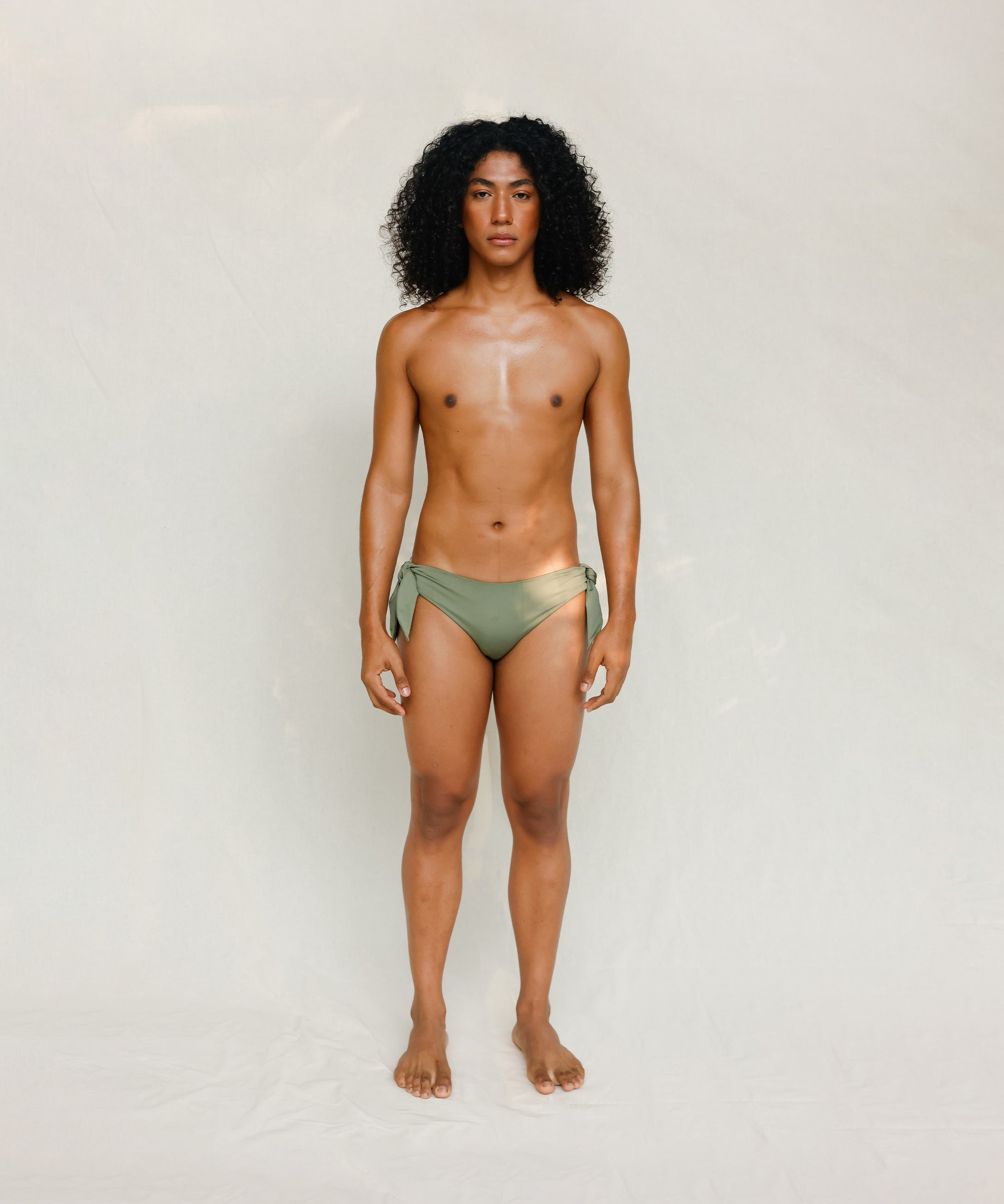 Front view of model wearing green knotted bikini bottom