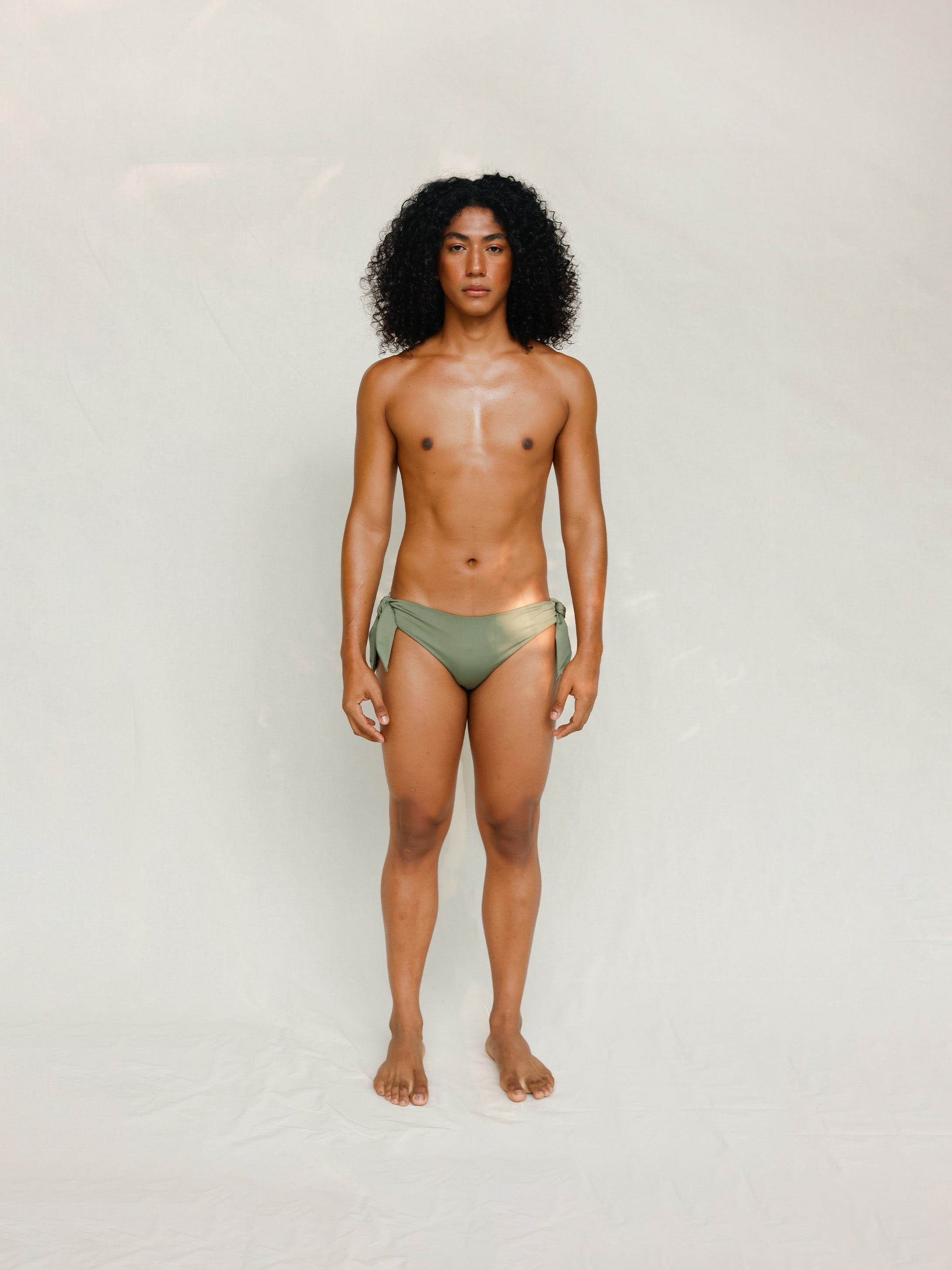 Front view of model wearing green knotted bikini bottom