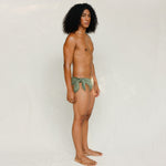 Side view of model in Sylvia bikini bottom, mineral green 