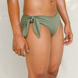 Side view of model in Sylvia bikini bottom, mineral green