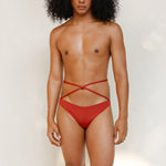 Terracotta red striped bikini bottom with anatomical coverage designed for a secure, gender-affirming and non-binary tuck-friendly fit.