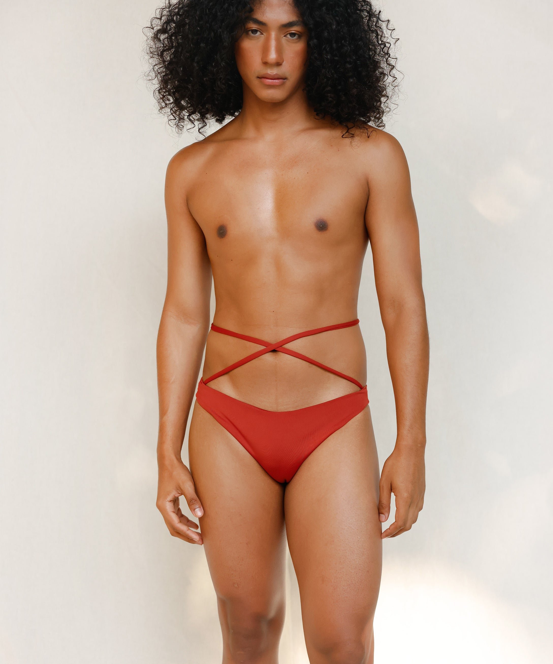 Terracotta red striped bikini bottom with anatomical coverage designed for a secure, gender-affirming and non-binary tuck-friendly fit.