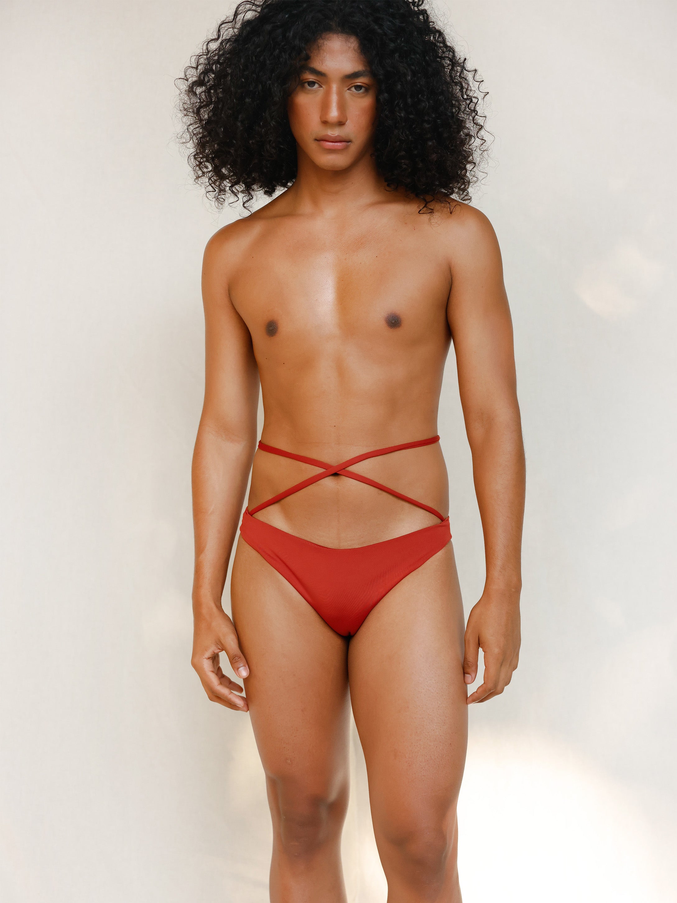 Terracotta red striped bikini bottom with anatomical coverage designed for a secure, gender-affirming and non-binary tuck-friendly fit.