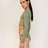 Side close-up of the Doris long-sleeve swim crop top rashguard in mineral green, a gender-neutral, nonbinary sustainable design with clean, minimal lines.