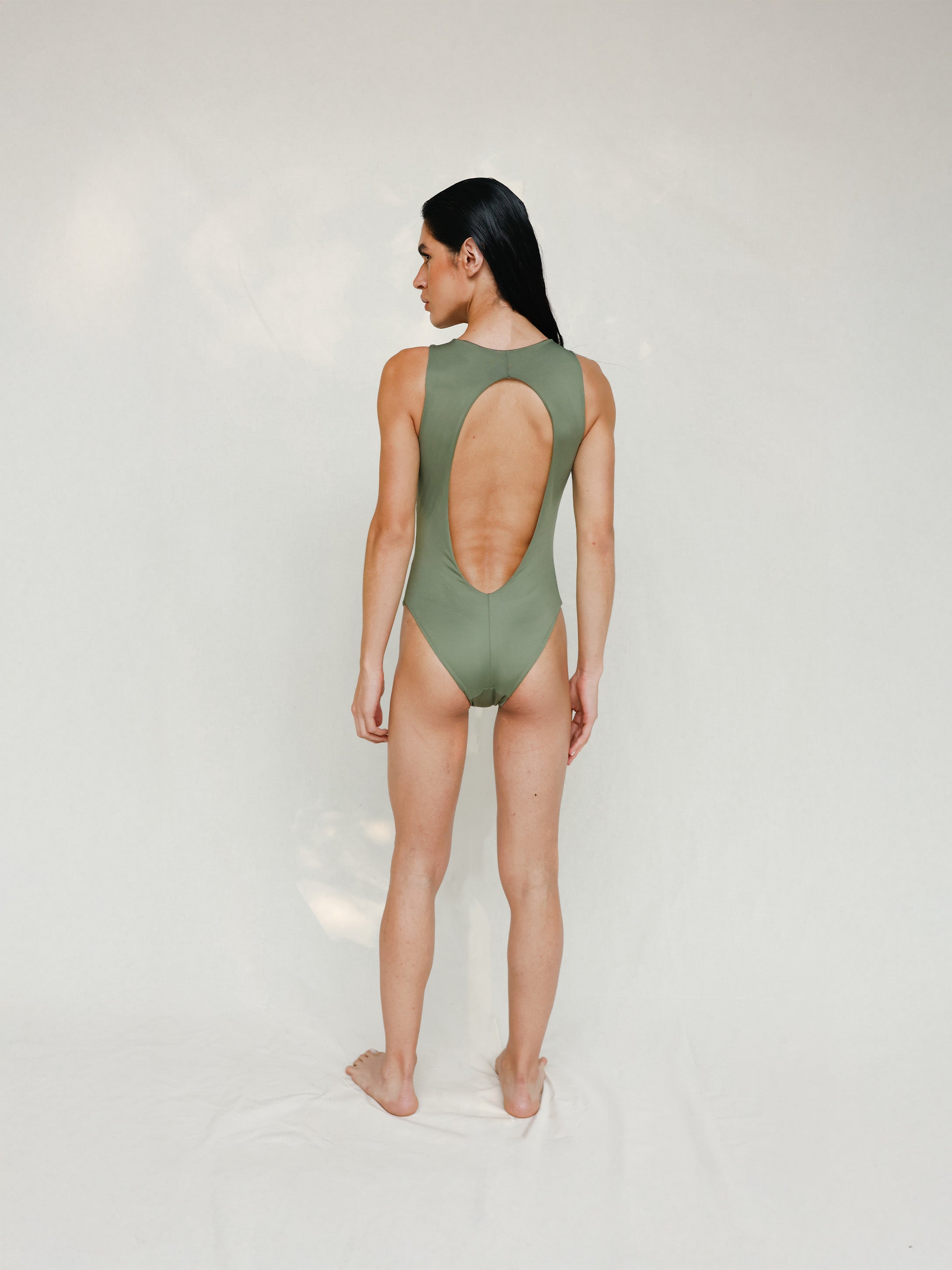 Person wearing Marsha one-piece swimsuit in mineral green, back view