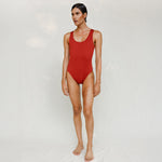 Person wearing Marsha one-piece swimsuit in terracotta red, front view