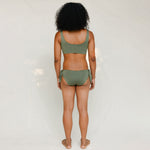 Back view of model in Audre top, mineral green