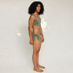 Side view of model in Audre top, mineral green 