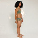 Side view of model in Audre top, mineral green 