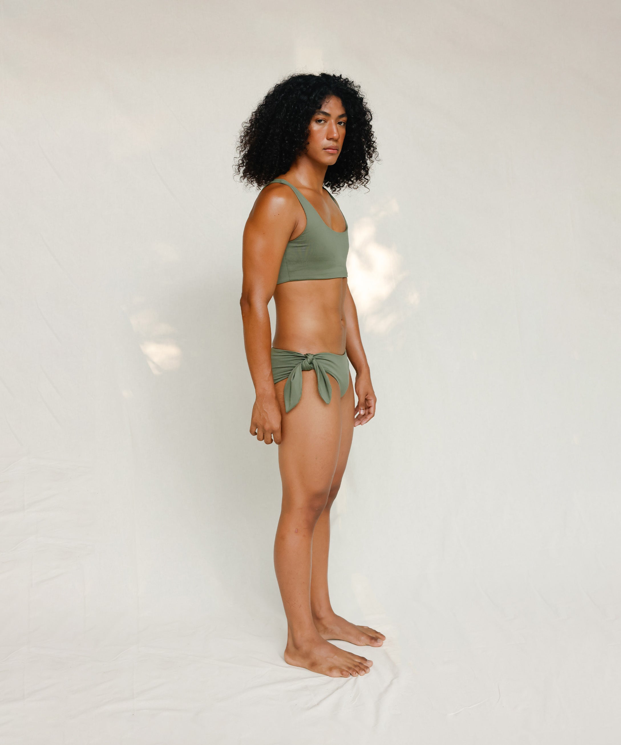 Side view of model in Audre top, mineral green 
