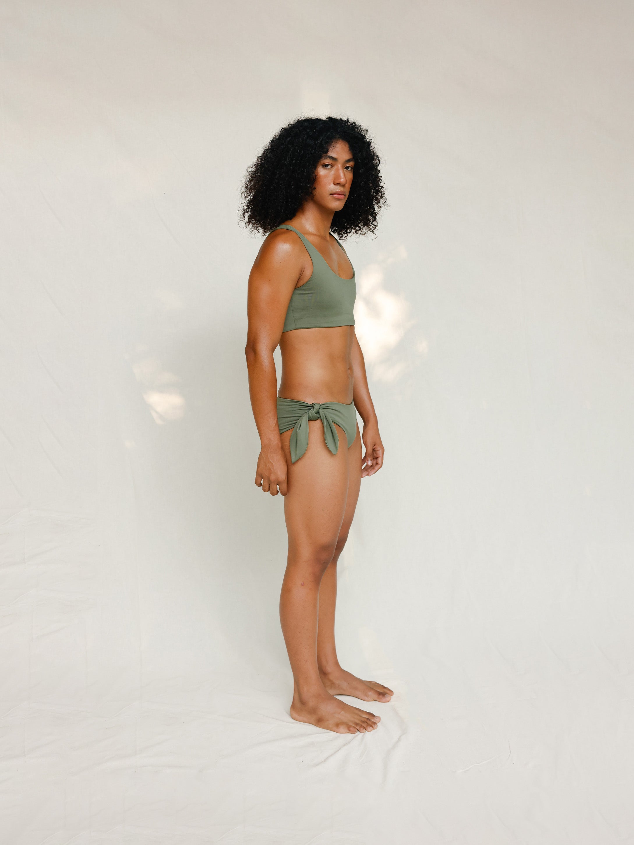Side view of model in Audre top, mineral green 