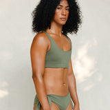 Side view of model in Audre top, mineral green