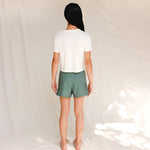 Back view of model in printed off-white cotton t-shirt 