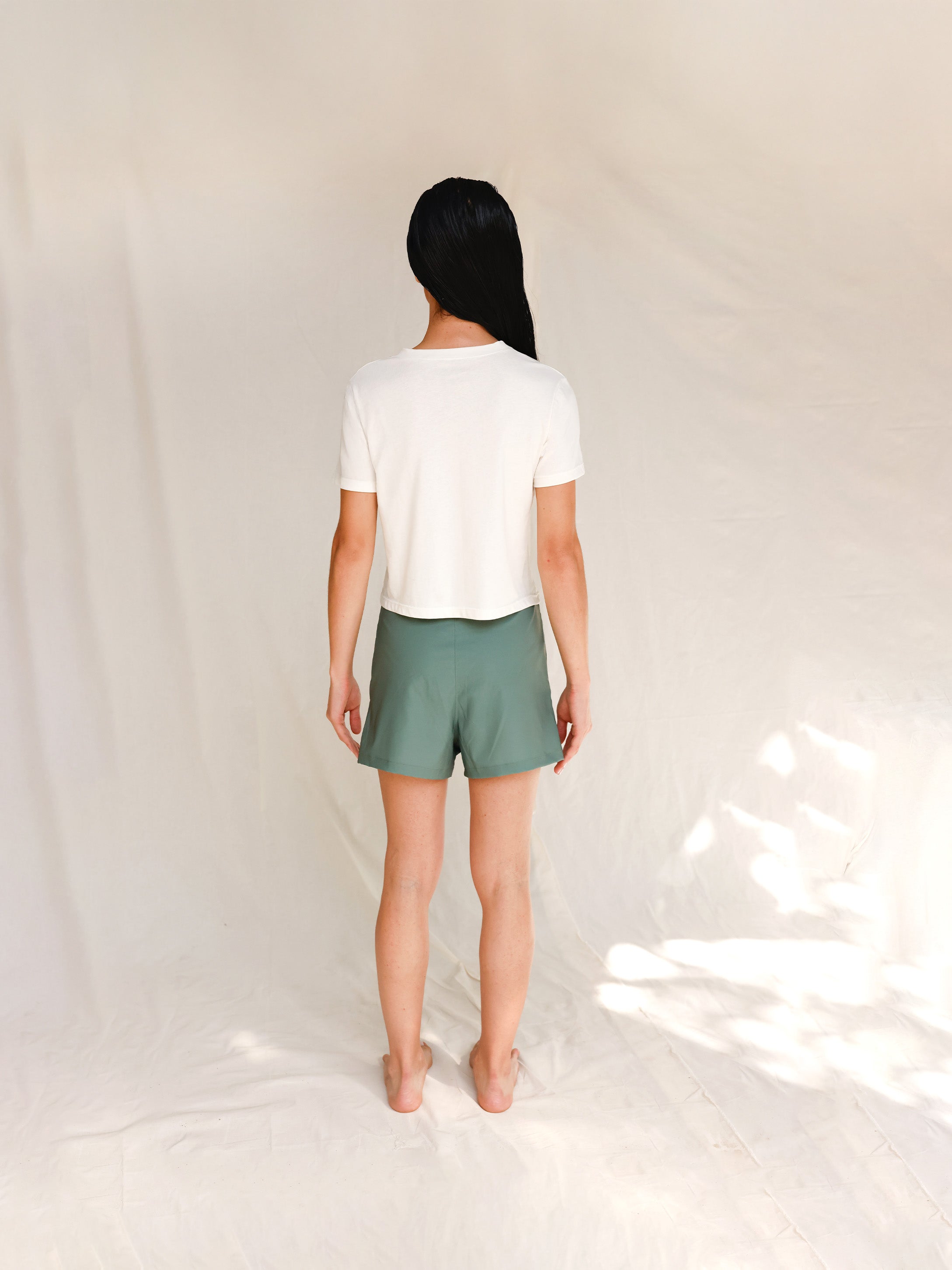 Back view of model in printed off-white cotton t-shirt 