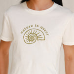 Close up front view of model wearing white tee with Nature is Queer print 