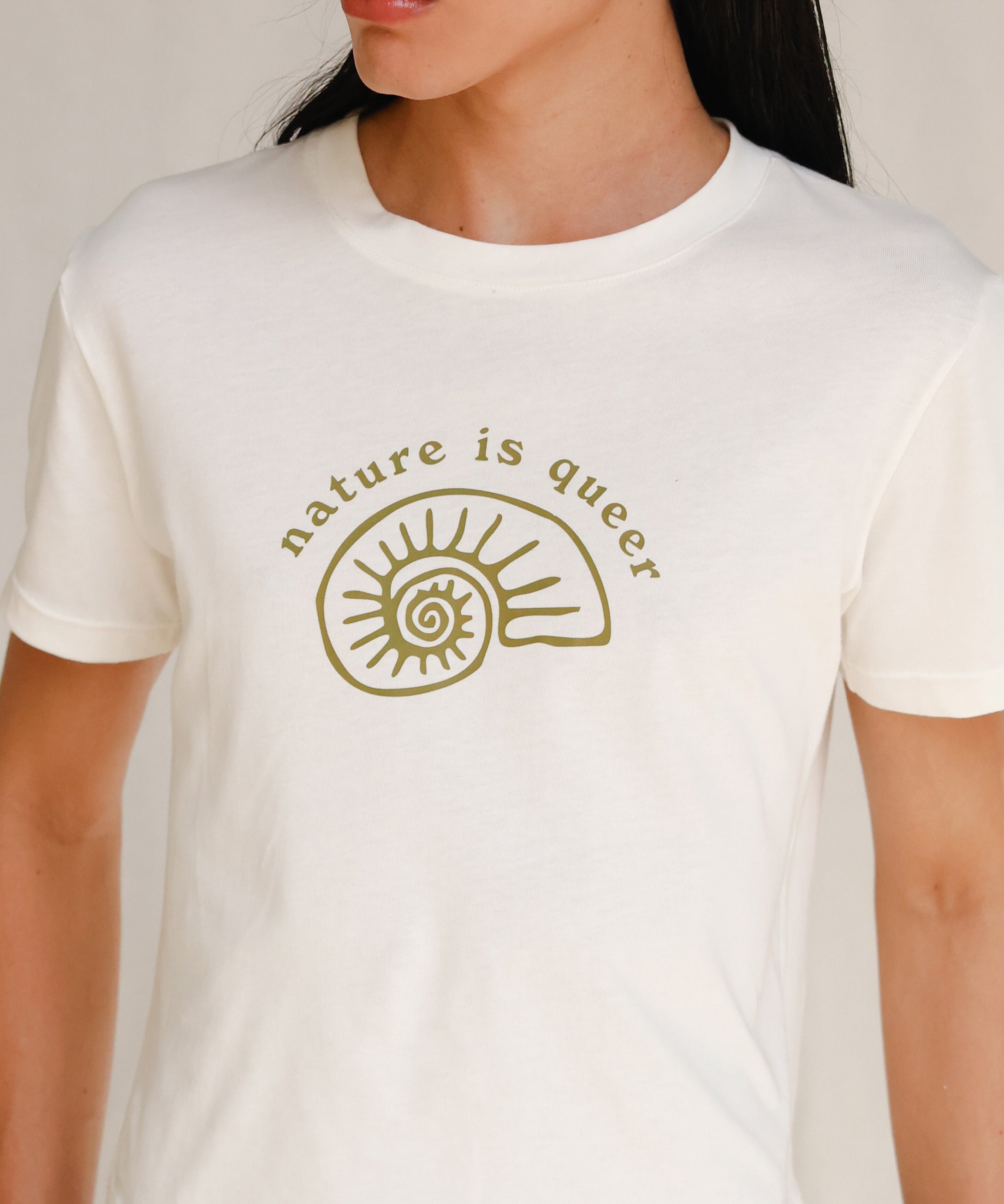 Close up front view of model wearing white tee with Nature is Queer print 
