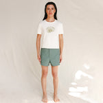 Front view of model wearing white tee with Nature is Queer print