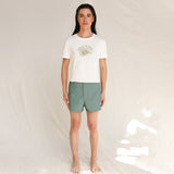 Front view of model wearing white tee with Nature is Queer print