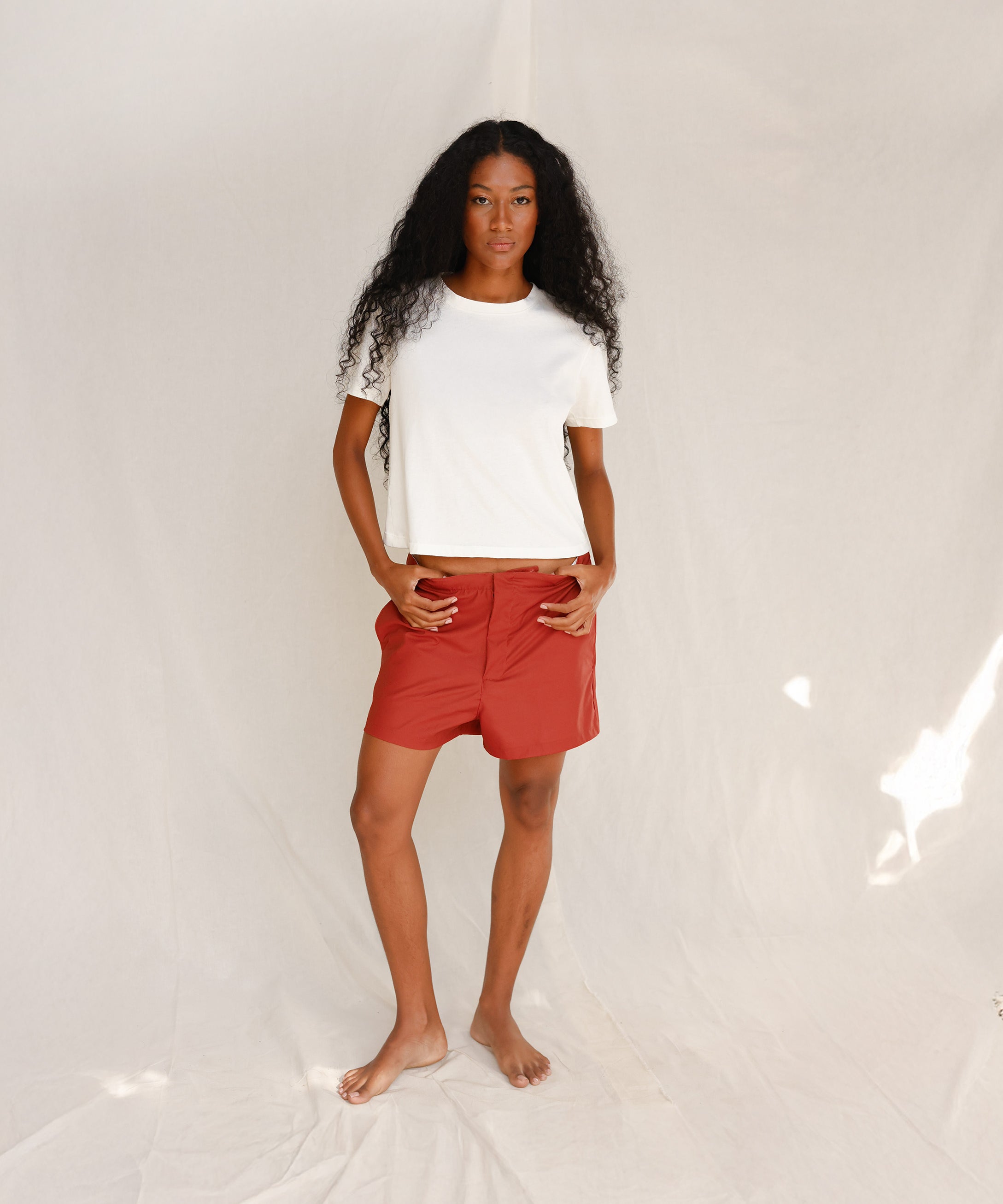Front view of model wearing plain off-white cotton t-shirt
