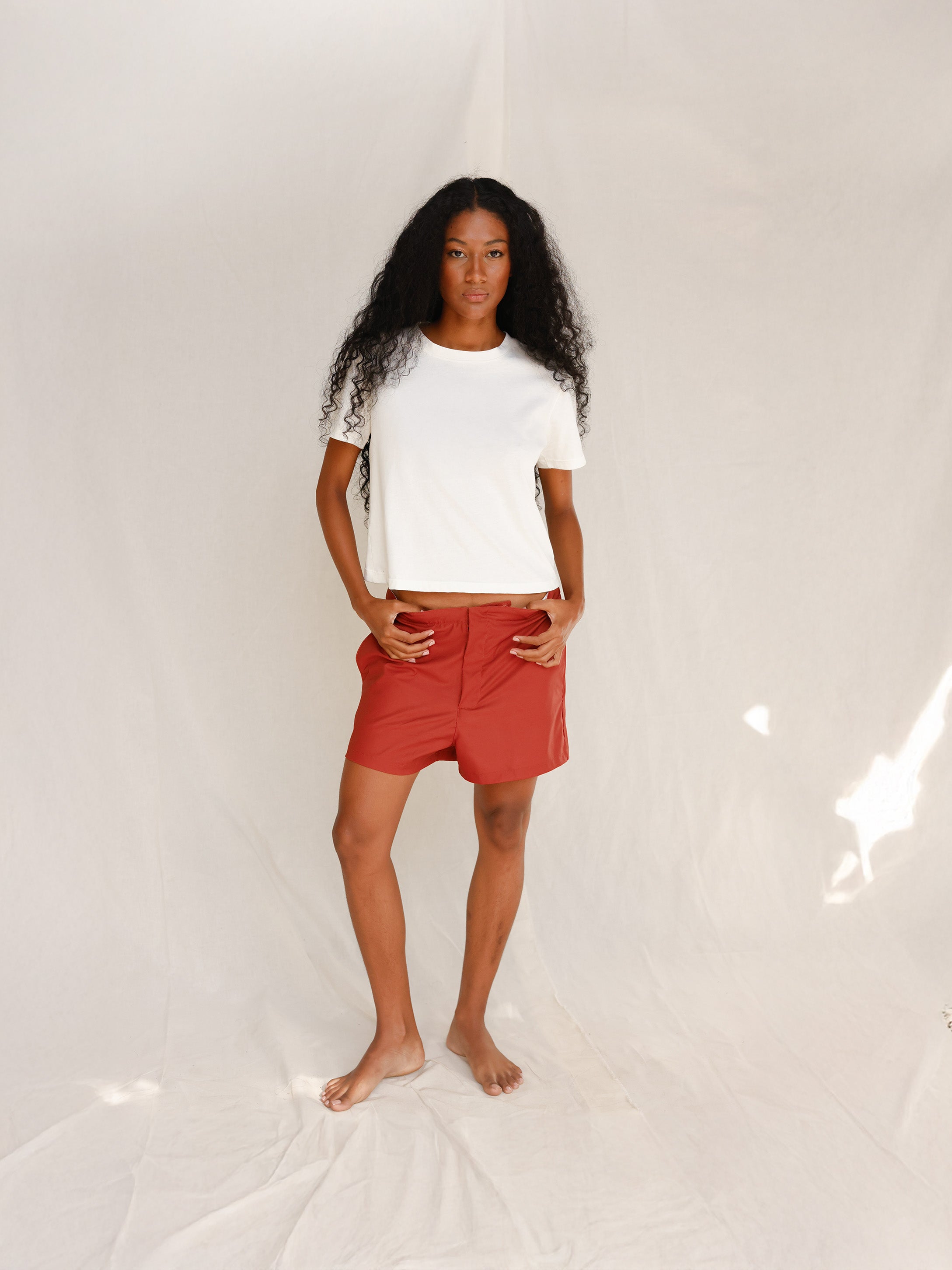 Front view of model wearing plain off-white cotton t-shirt
