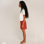 Side view of model in off-white tee 